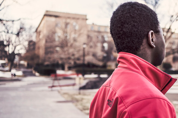 Man Outside Black man in a red jacket outside